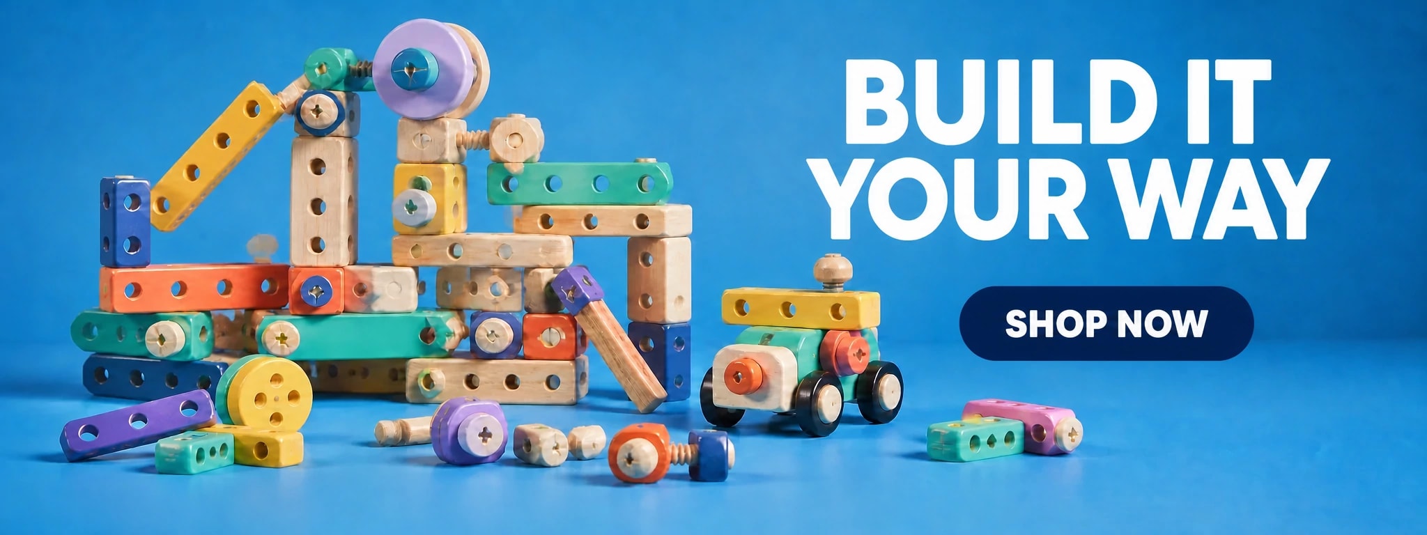 Colourful wooden construction toys and a small toy vehicle on a blue studio set
