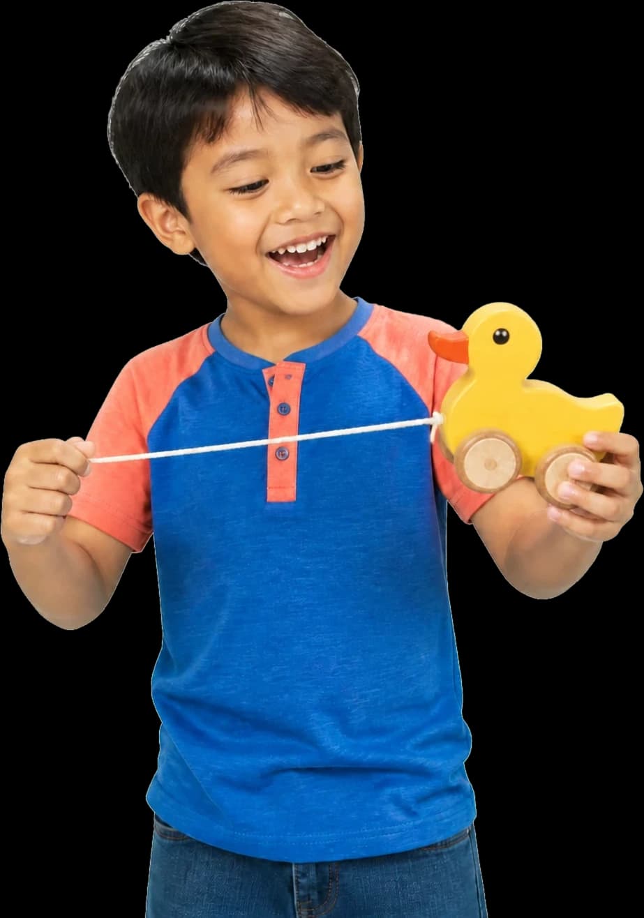 Happy child playing with a yellow wooden duck toy